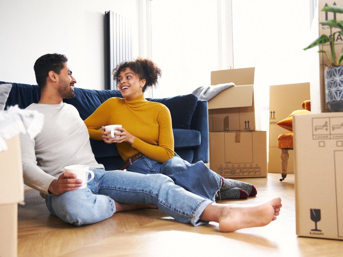 Couple talking surrounded by moving boxes